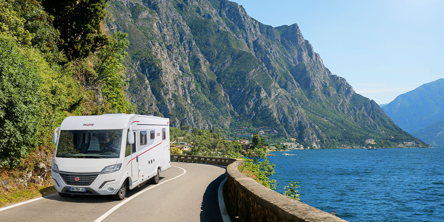 camping-car intégral Pilote roulant le long d'un lac des Balkans